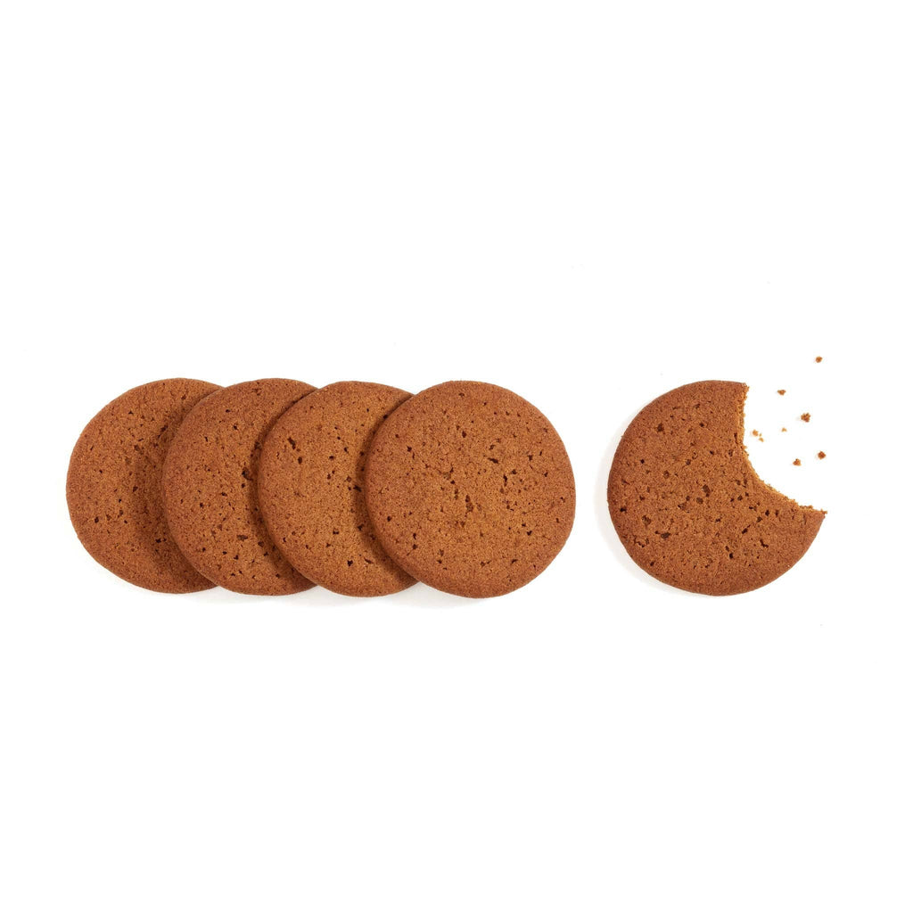 Rustic Bakery ginger snap cookies stacked on a plate, showcasing their crispy, spiced texture and golden-brown color.