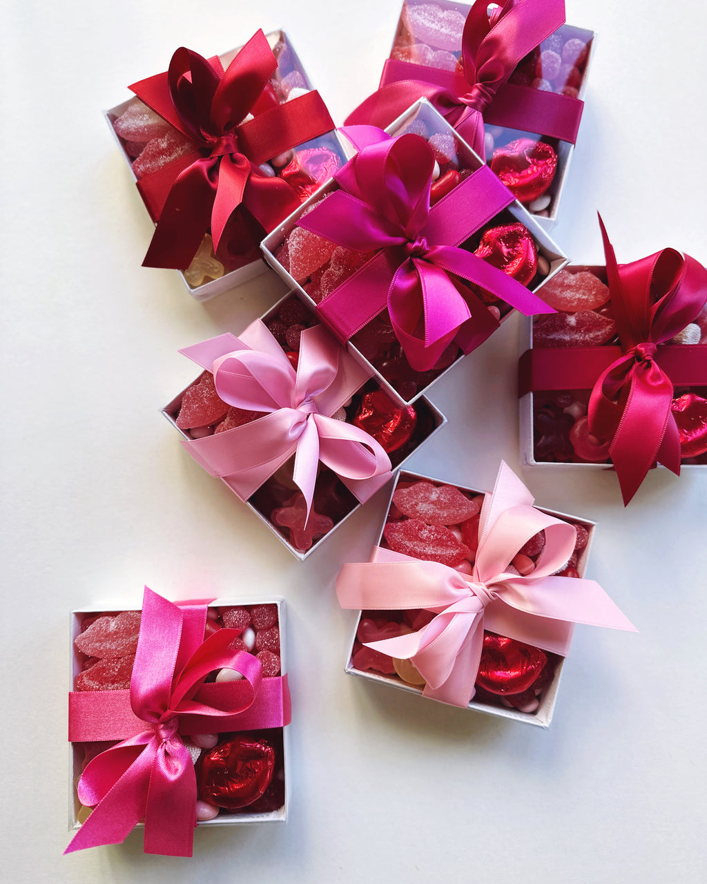 Set of 24 custom chocolate and candy boxes by Poppins & Post, featuring colorful packaging for sweets and treats.