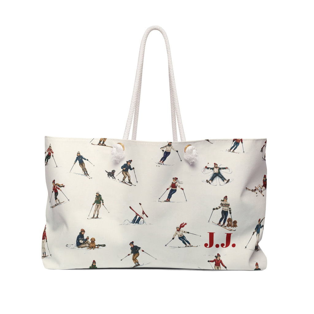 An off-white tote bag with a vintage-style allover print of skiers and snowboarders, featuring two white rope handles and the initials 'J.J.