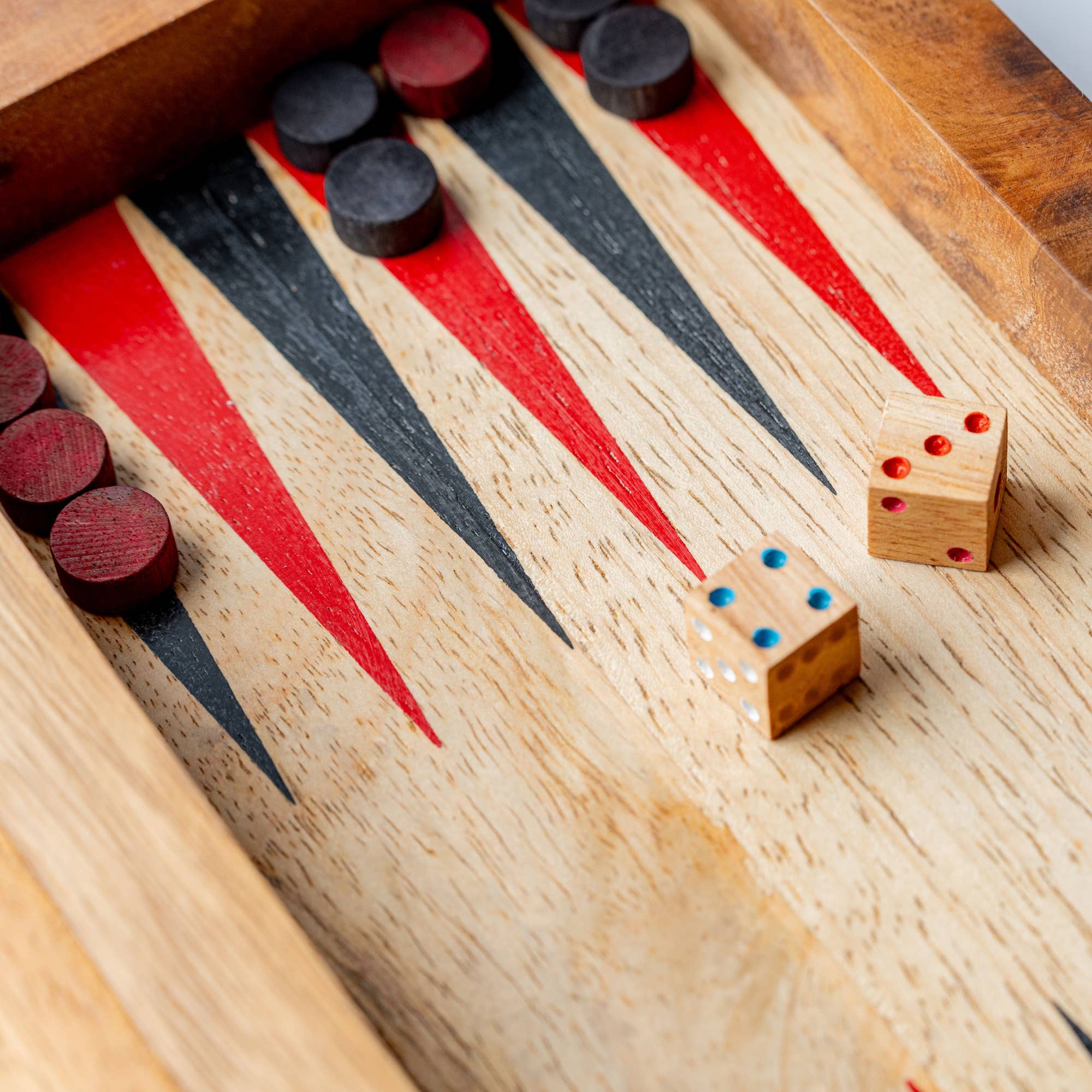 Backgammon game set with mango wood surface and checkered design, featuring game pieces and dice for traditional gameplay.