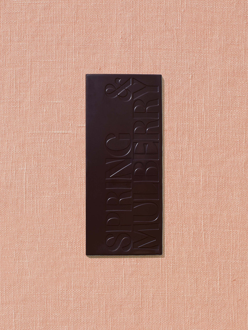 Chocolate bar with 'Spring & Berries' branding on a beige background