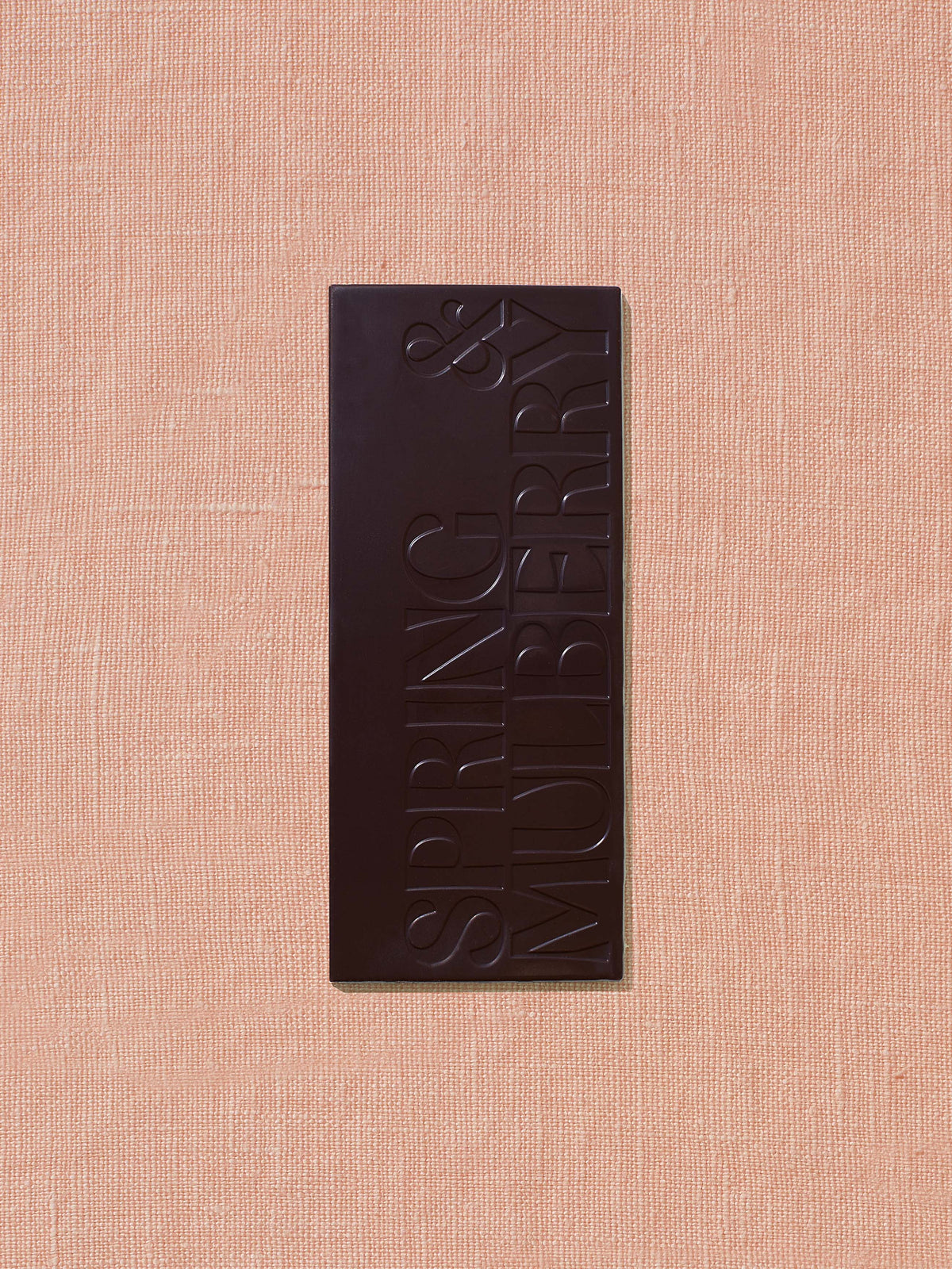Chocolate bar with 'Spring & Berries' branding on a beige background