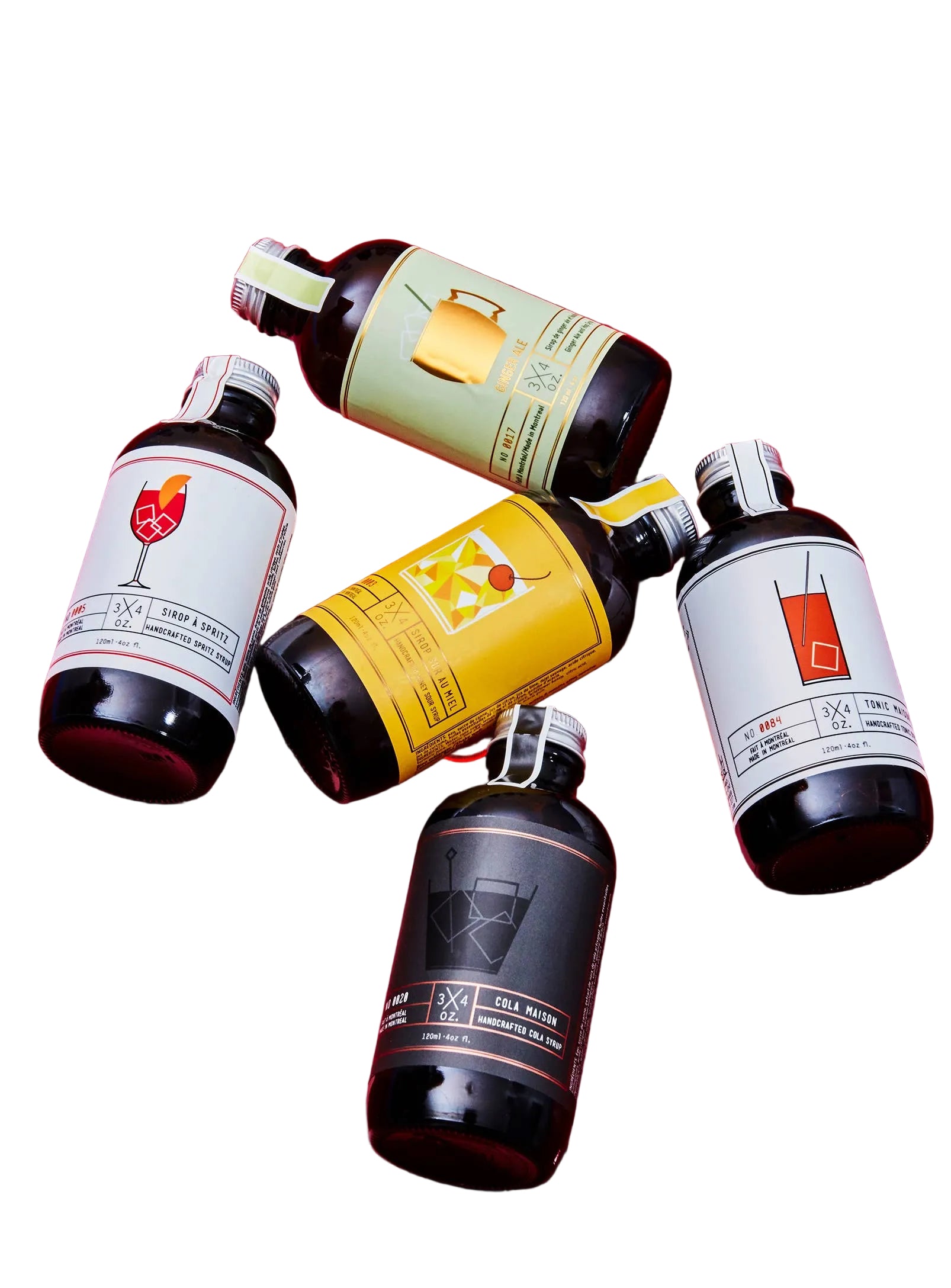 Deluxe Cocktail and Mocktail Kit with 3/4 oz. Tonic bottle, colorful ingredients, and cocktail tools on a wooden surface.