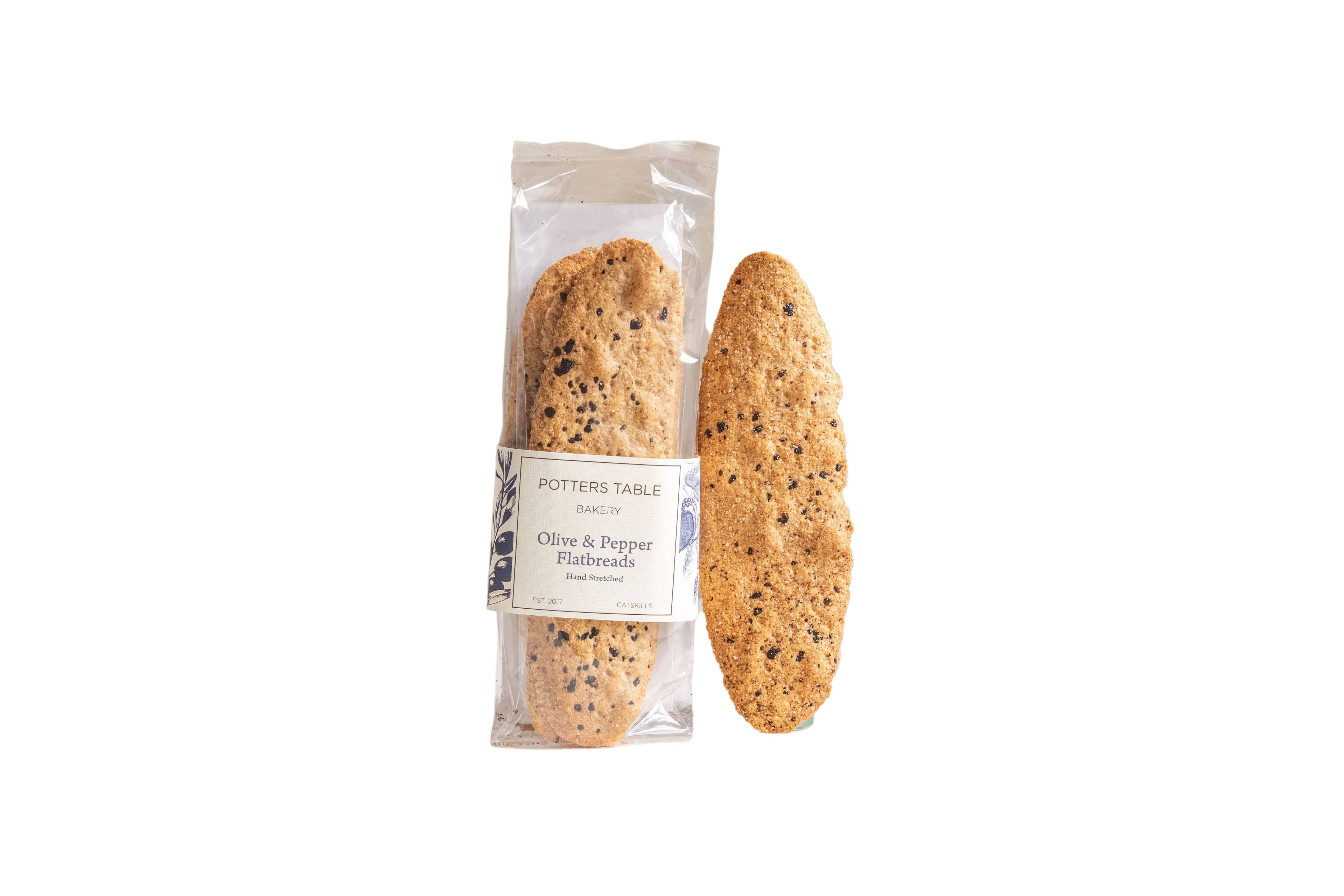 Potters Table cured olive and cracked pepper flatbreads crackers on a wooden serving board.