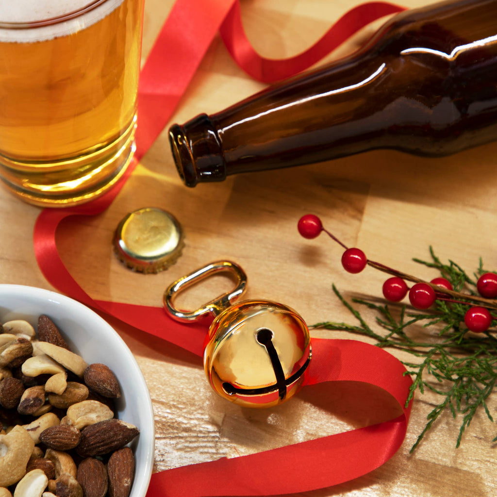 Gold plated metal jingle bell beer bottle opener with ribbon, kitchen gadget by Twine, featuring festive holiday design.