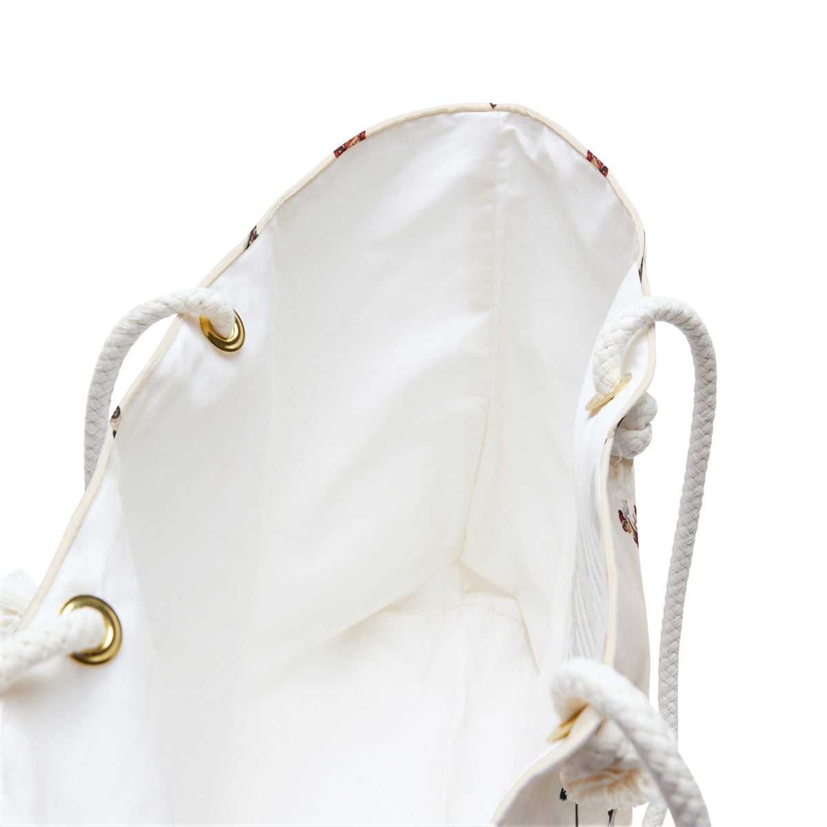White drawstring bag with gold accents on a white background