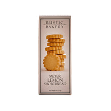 Rustic Bakery Meyer Lemon Shortbread Cookies on a white plate, showcasing golden-brown, buttery cookies with lemon zest.