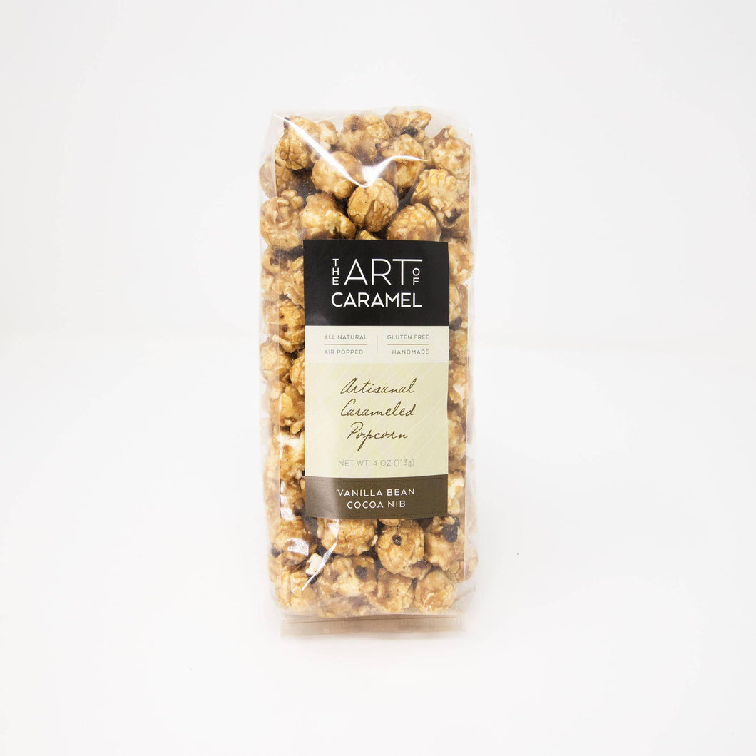 Vanilla bean caramel popcorn with cocoa nibs in a 4 oz bag by The Art of Caramel, showing golden popcorn coated with caramel and cocoa nibs.