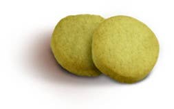 Lady Joseph butter cookies with pistachio cream filling, showcasing golden cookies topped with pistachio pieces.