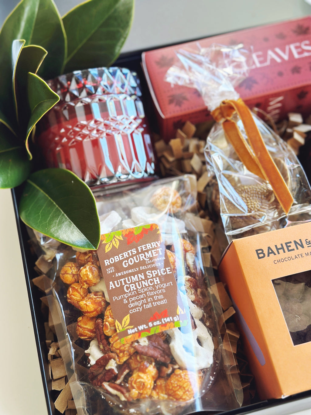 Fall Hostess gift box from Poppins & Post with festive packaging and assorted treats in a decorative tin.