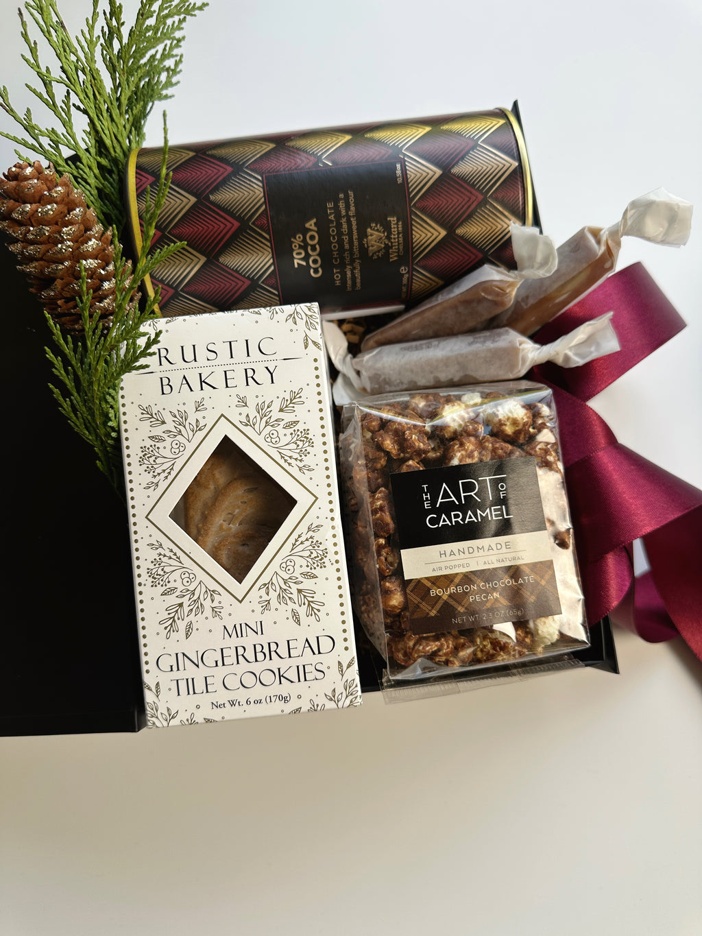 Gift box of cocoa and cookies from Poppins & Post featuring assorted chocolates and baked treats arranged inside a decorative box.