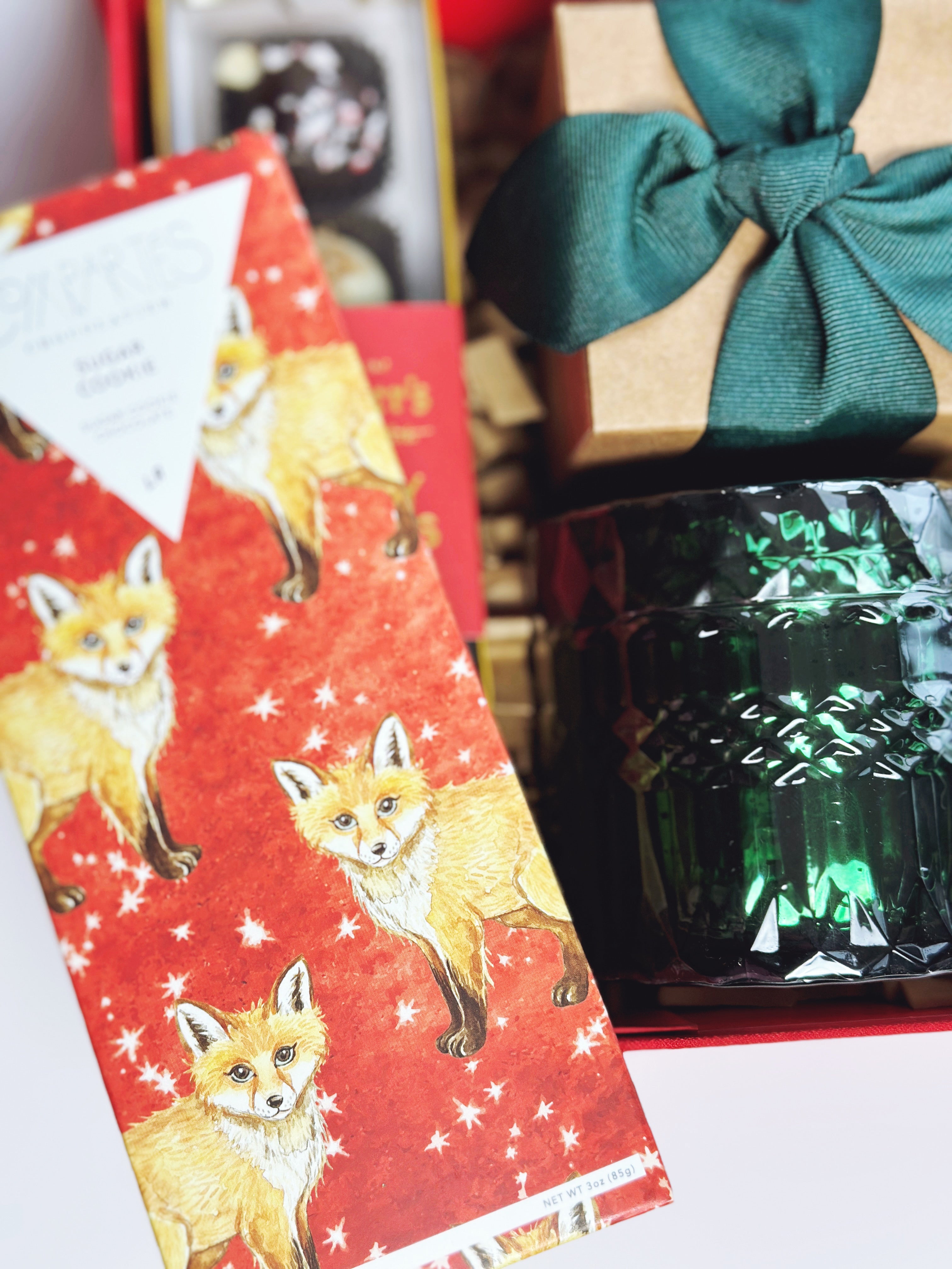 Assorted holiday sweets gift box from Poppins & Post with festive treats and colorful packaging.