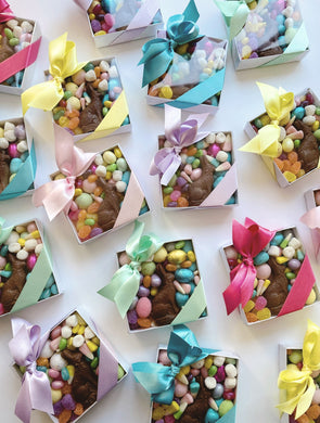 Set of two Poppins & Post individual Easter candy boxes filled with colorful treats and festive packaging.