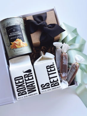 Sweet and salty wedding welcome favors by Poppins & Post, featuring assorted treats in decorative packaging.