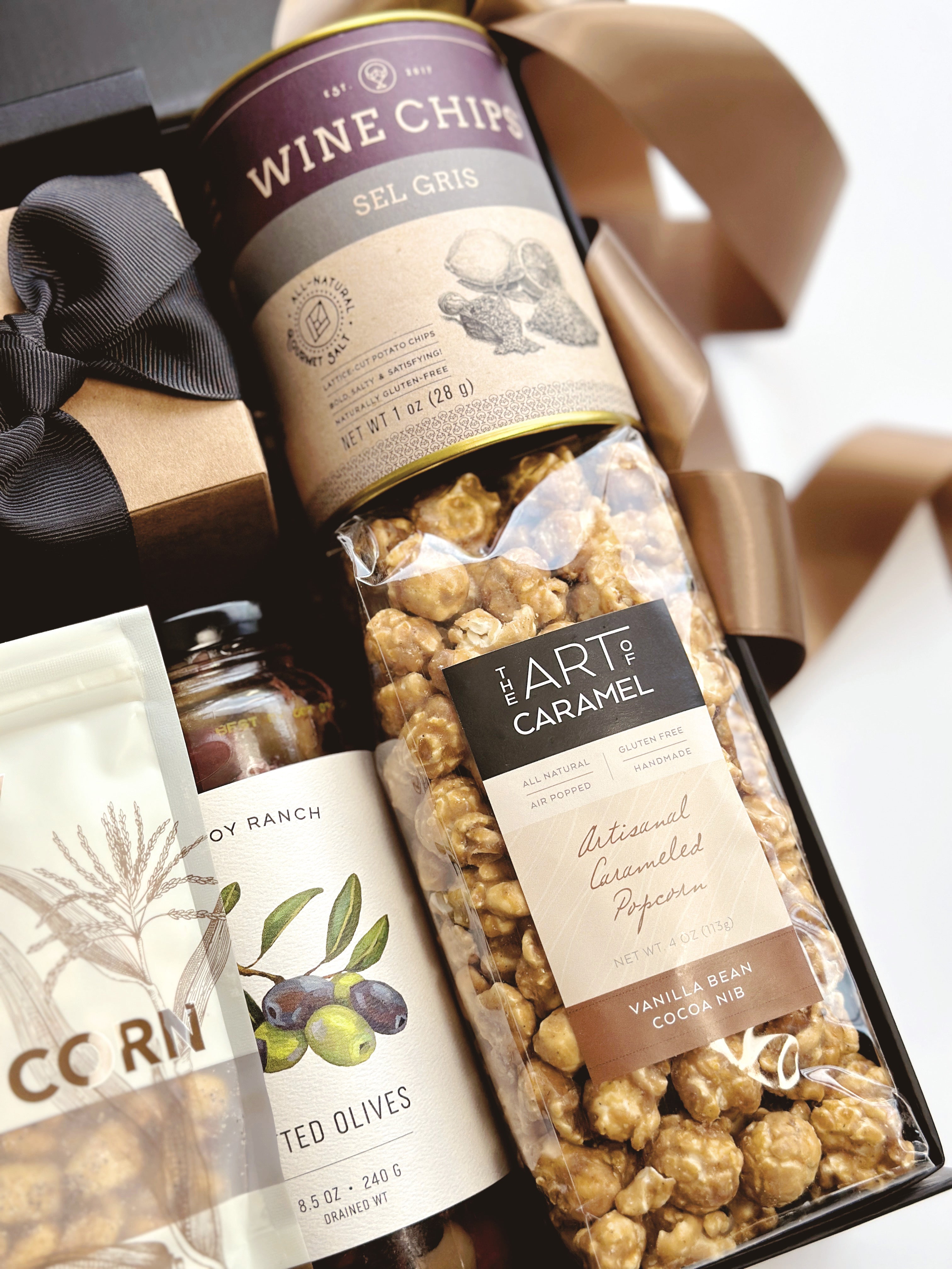 Black and Tan gift box by Poppins & Post, featuring an elegant assortment of chocolates and treats in a stylish packaging.