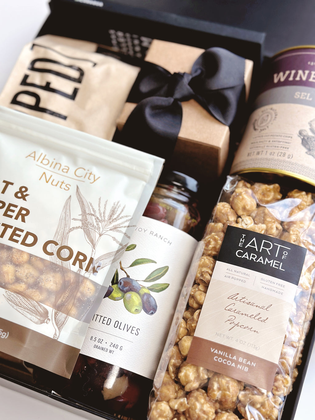 Black and Tan gift box from Poppins & Post featuring a stylish packaging with assorted treats and elegant design.