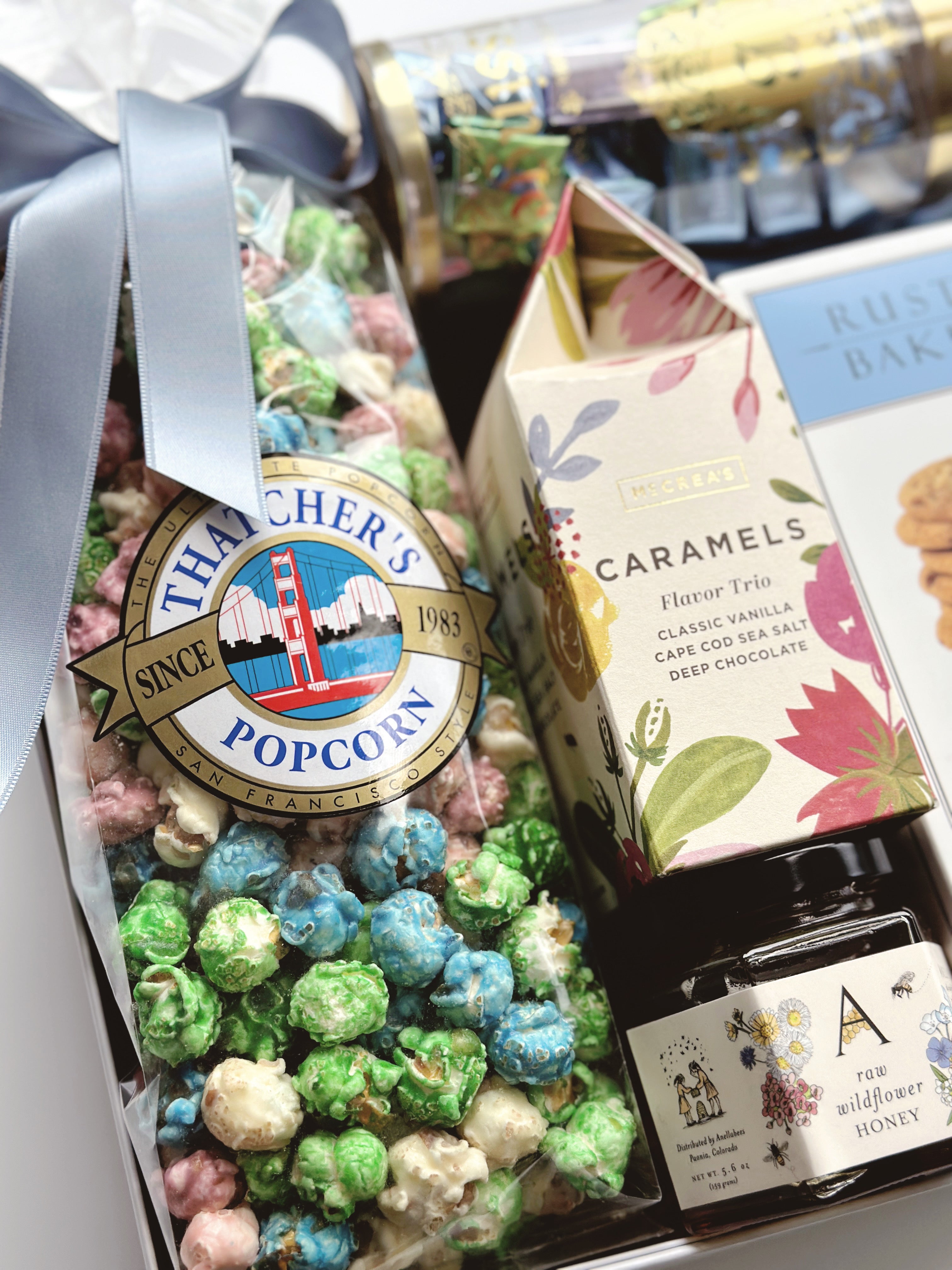 Poppins & Post The Artisan Spring Box gift box with colorful spring-themed paper and decorative accents.