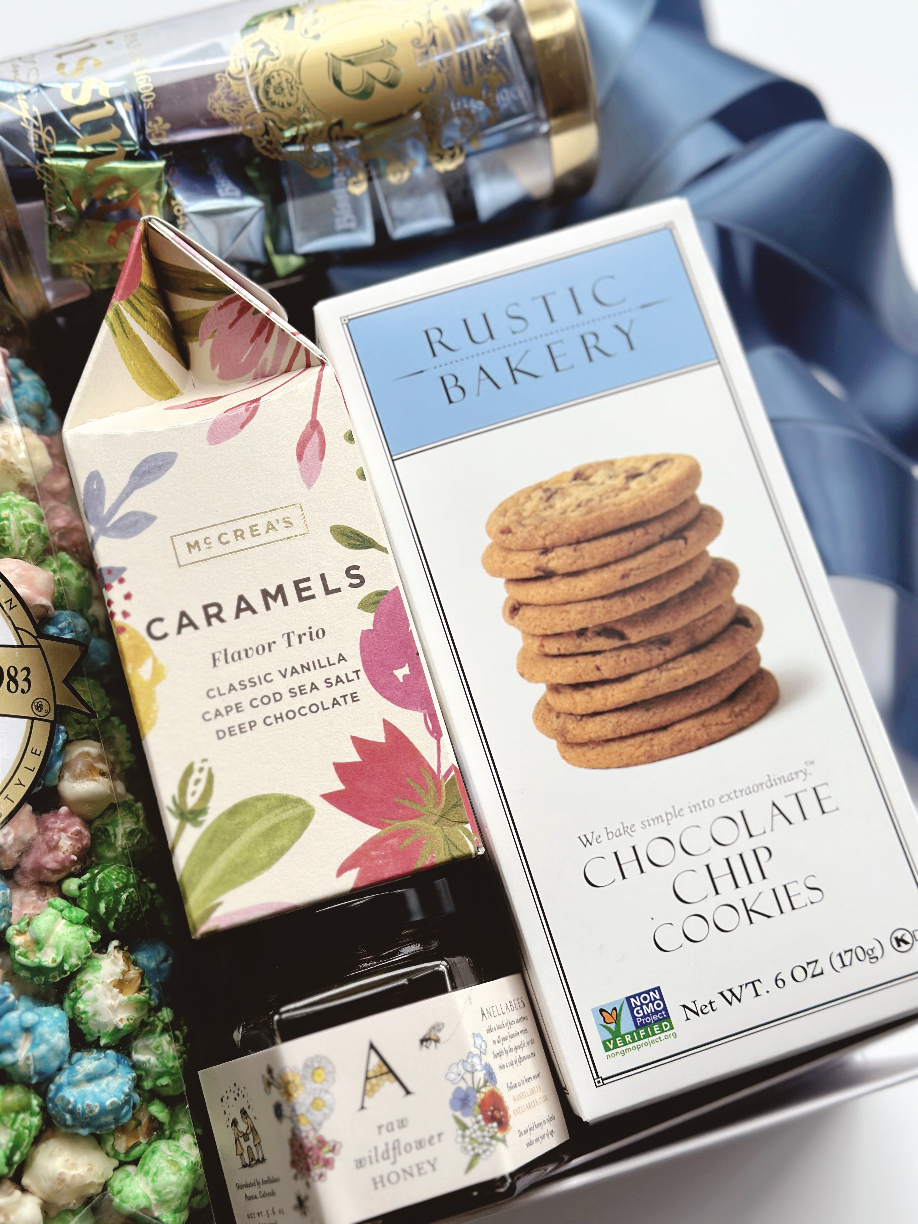 Poppins & Post The Artisan Spring Box gift box with floral wrapping and assorted artisanal treats arranged inside.