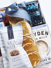 Gift box of Snacks by the Sea by Poppins & Post with assorted seaside-themed snacks in a decorative gift box.