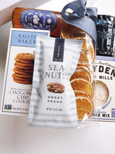 Gift box of assorted snacks by the sea from Poppins & Post, featuring a variety of seaside-inspired treats and packaging.
