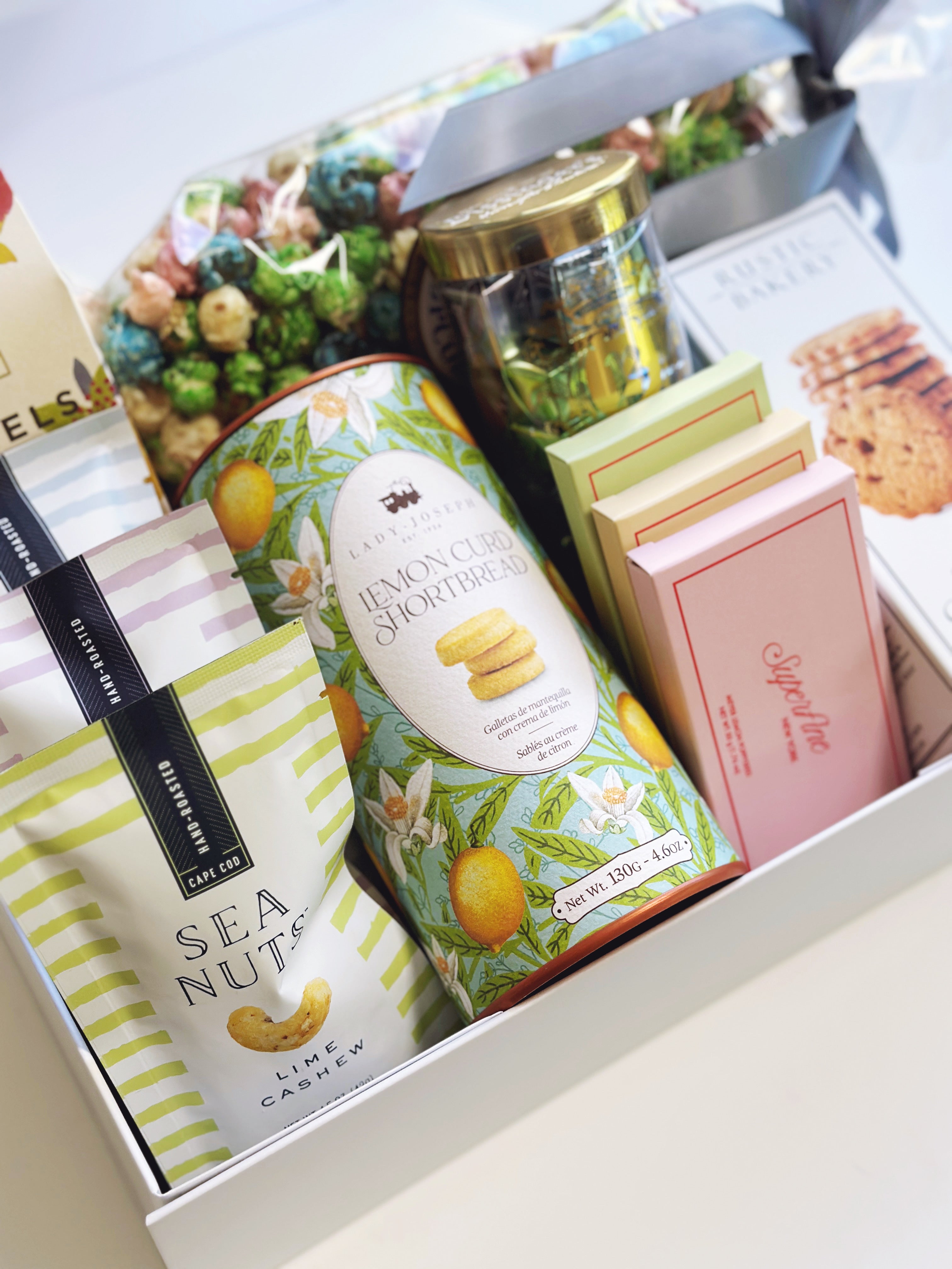 Poppins & Post The ULTIMATE treat box gift box with assorted sweets and snacks arranged inside.