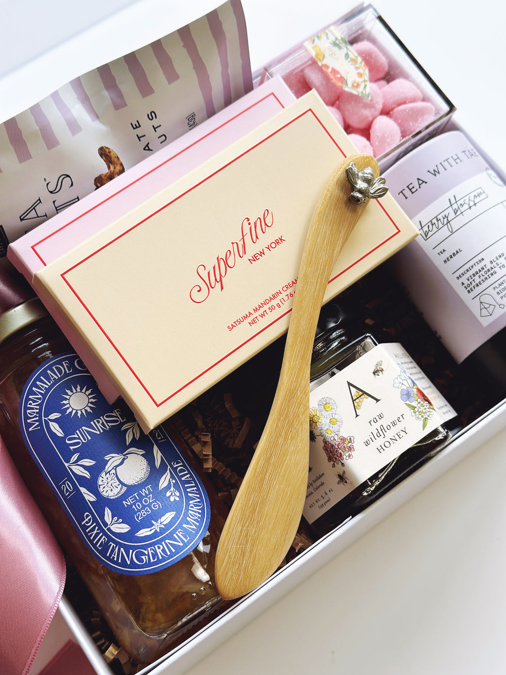 Gift set with a wooden spoon, tea, and other items in a box.