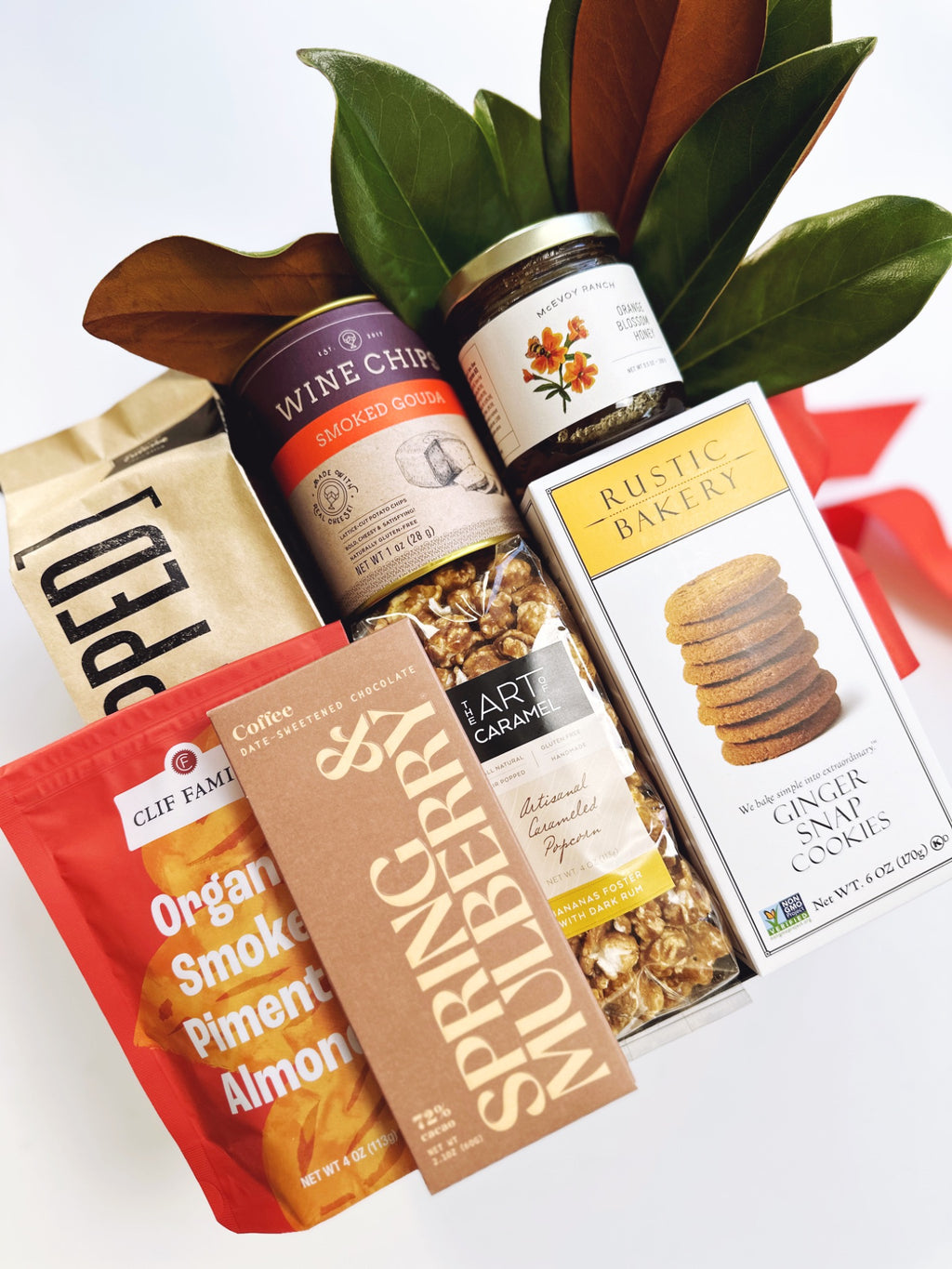 Gift box with ginger snap cookies, Bananas Foster caramel corn, smoked gouda chips, McEvoy Ranch honey, smoked pimentón nuts, smoked cheddar popcorn, and coffee date-sweetened chocolate.