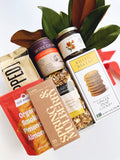 Gift box with ginger snap cookies, Bananas Foster caramel corn, smoked gouda chips, McEvoy Ranch honey, smoked pimentón nuts, smoked cheddar popcorn, and coffee date-sweetened chocolate.