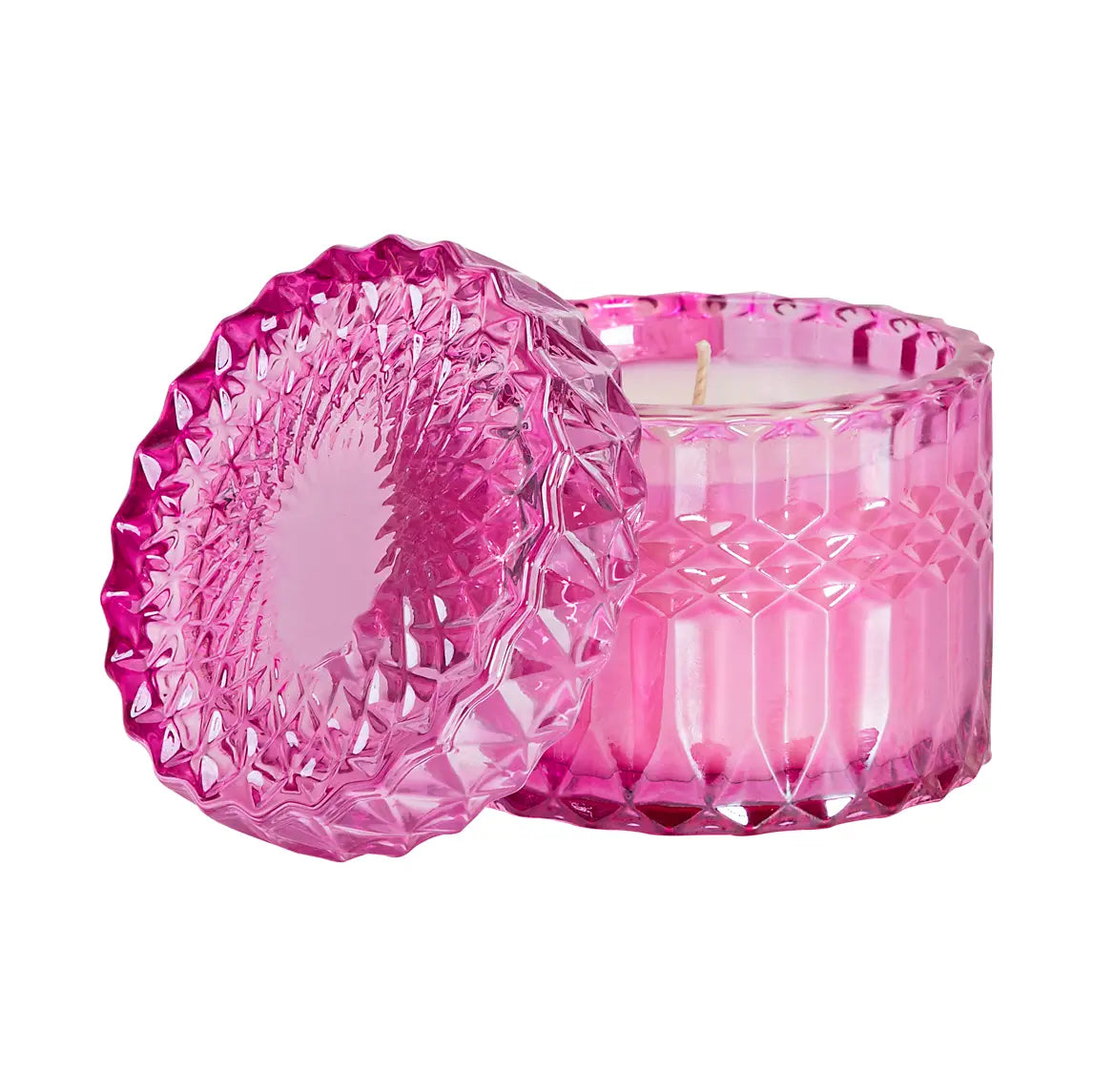 Gift-wrapped crystal candle from Poppins & Post, shown on a breakfast table with a cake and flowers in the background.
