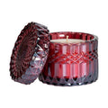 Gift-wrapped crystal candle from Poppins & Post featuring a festive cranberry-colored candle in a clear glass holder.