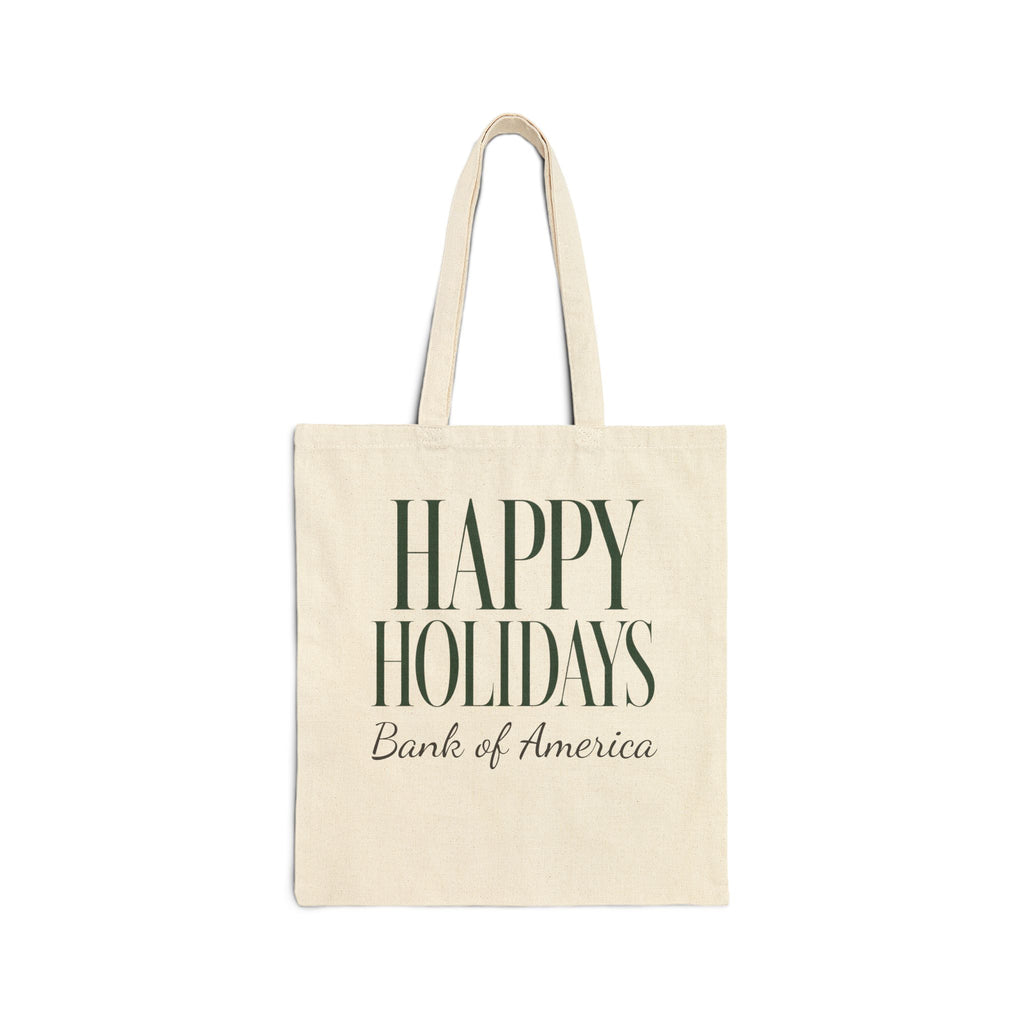 An off-white canvas tote bag with long handles, featuring the text 'HAPPY HOLIDAYS' in dark green serif letters and 'Bank of America' in dark brown script underneath, shown on a plain white background.