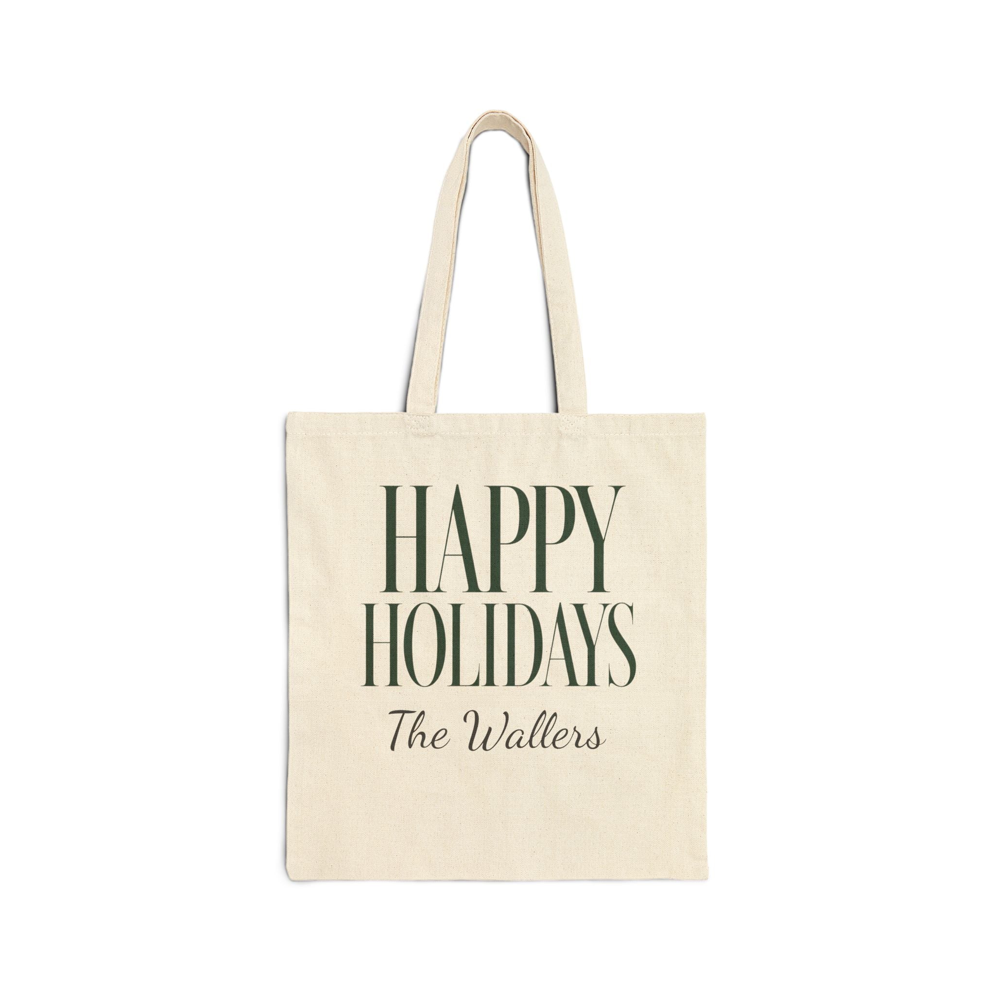 An off-white canvas tote bag with dark green text reading 'HAPPY HOLIDAYS' and 'The Wallers' underneath, shown against a plain white background.