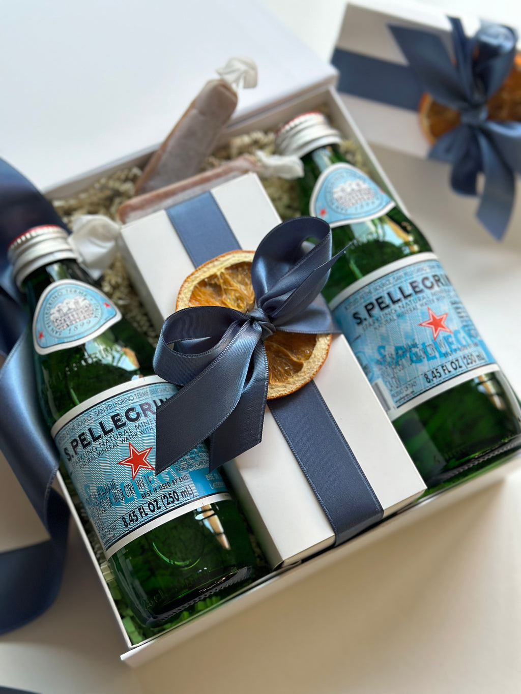 Set of 12 wedding arrival welcome gifts from Poppins & Post, featuring elegant, personalized keepsake boxes for guests.