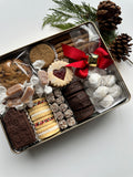 Large rectangle tin filled with assorted cookies for holiday gifting.
