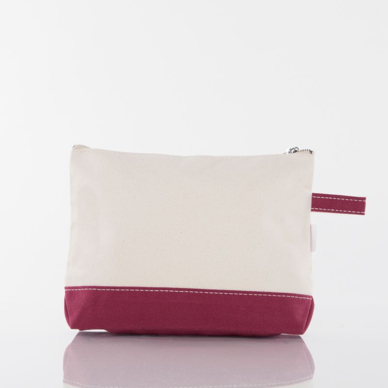 A small zippered pouch with a cream canvas upper section and a magenta-pink bottom band and matching wrist strap, shown on a clean white background.