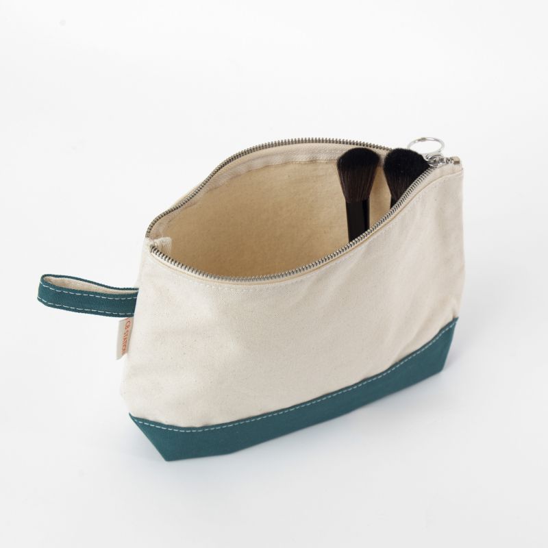 Beige toiletry bag with teal base on a white background