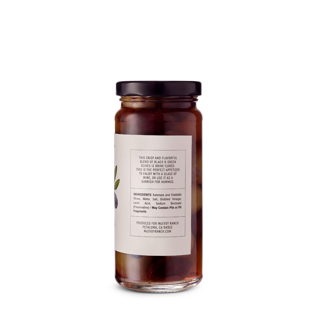 Pitted McEvoy Ranch Table Olives in 4.25 oz jar, showcasing shiny green olives ready for snacking or cooking.