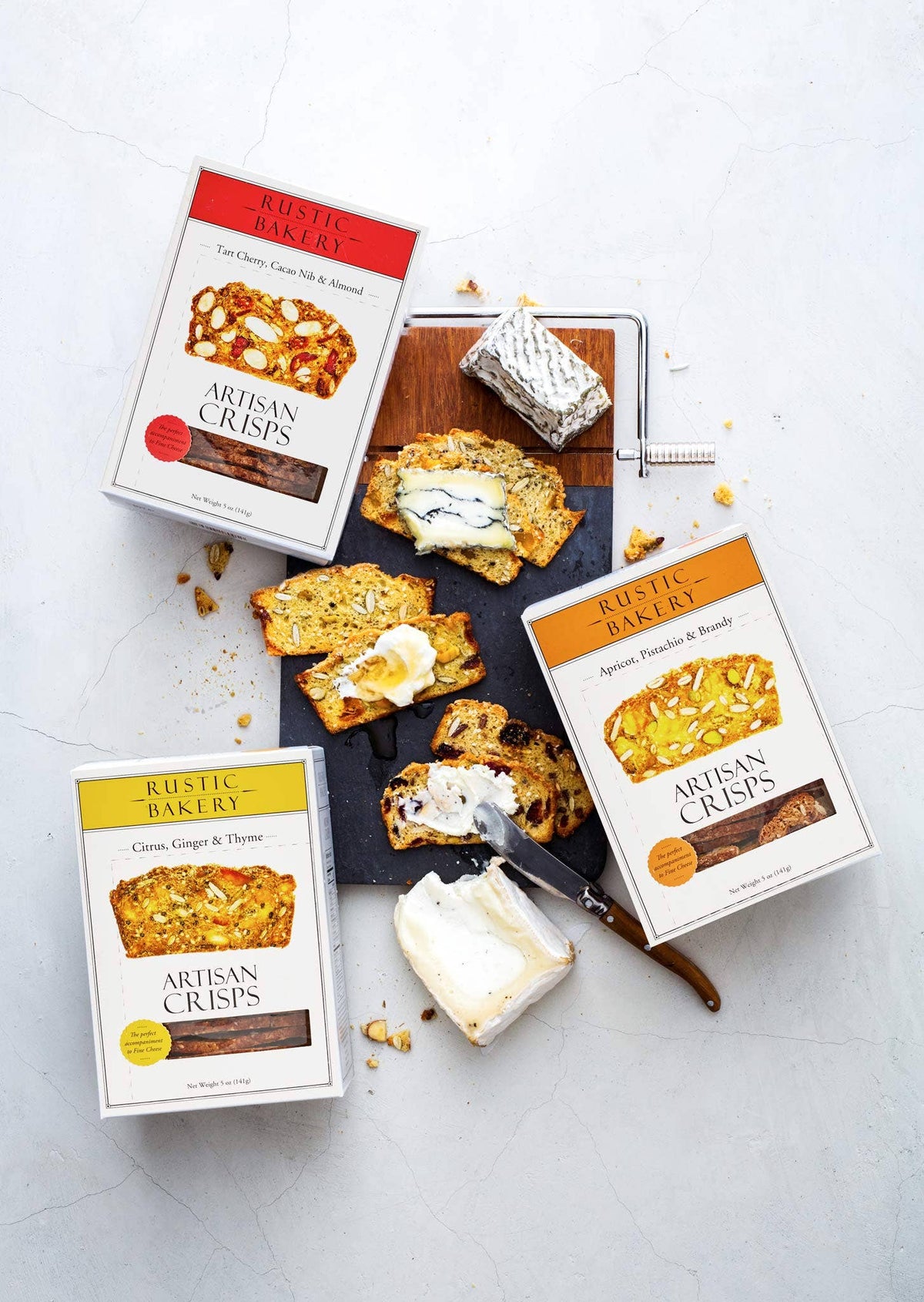 Rustic Bakery Artisan Crisps packaging with crackers on a white background