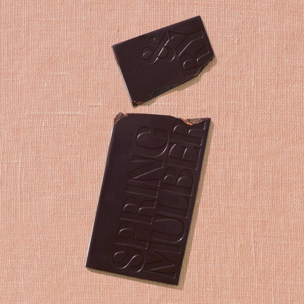Chocolate bar with 'Spring Nuber' branding on a beige textured surface