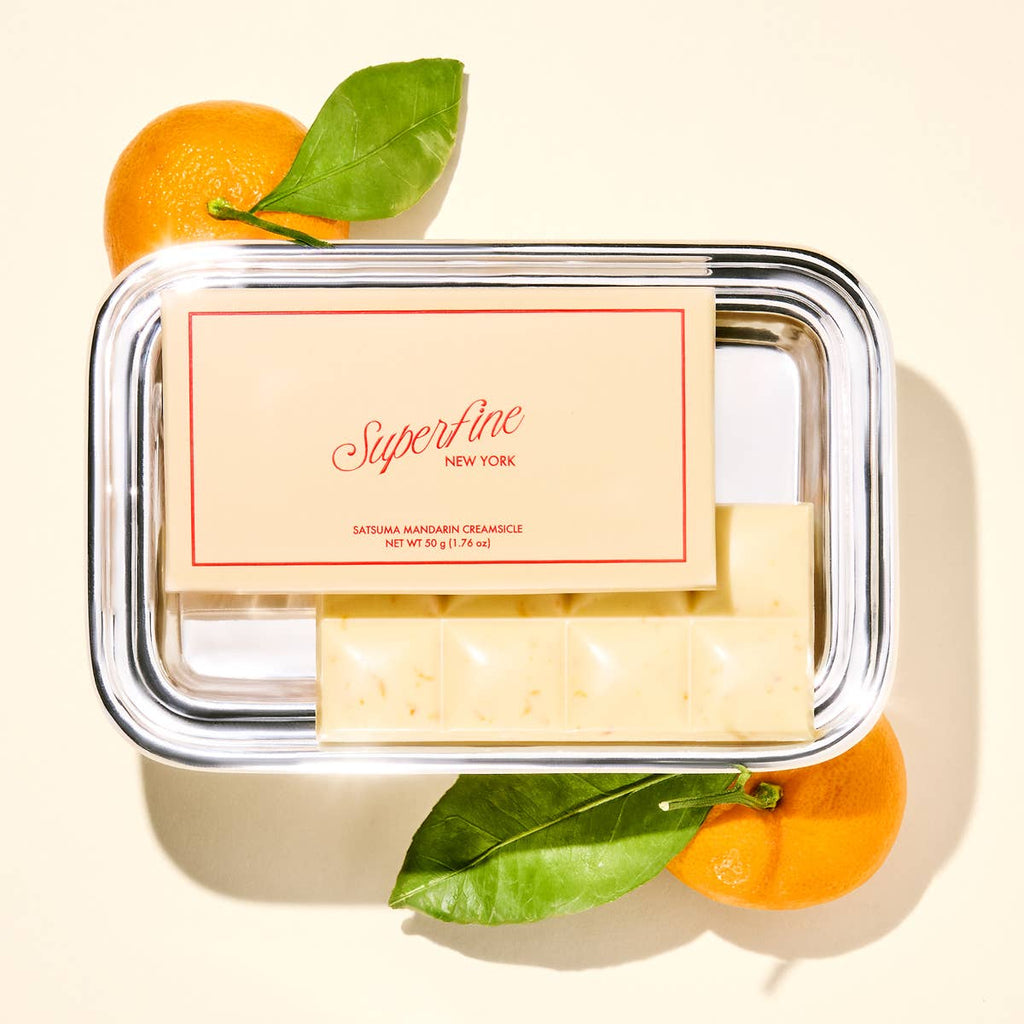 Superfine Chocolate Satsuma Creamsicle Bar featuring chocolate coating and orange-flavored candy filling on a white background.