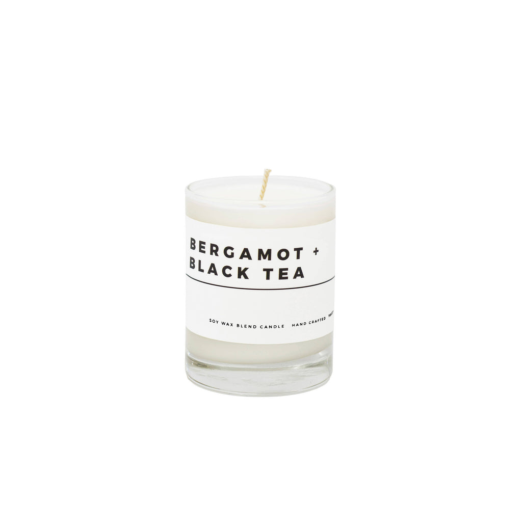 True Hue Bergamot and Black Tea Mini Candle with a sleek glass holder, featuring a warm, inviting flame.