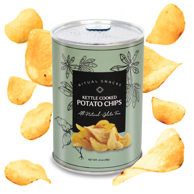 Can of kettle cooked potato chips with chips scattered around on a white background