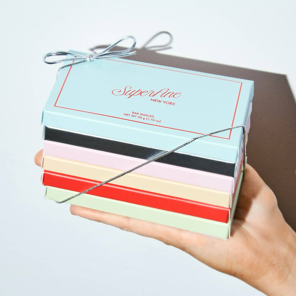 Superfine Satsuma Creamsicle chocolate and candy bar with orange and vanilla flavors, wrapped in colorful packaging.