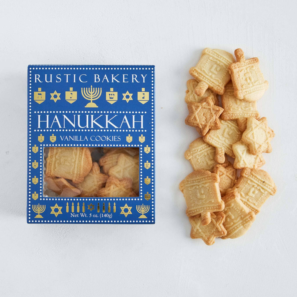 Rustic Bakery Hanukkah cookies with festive shapes and colorful icing on a plate, celebrating Hanukkah traditions.
