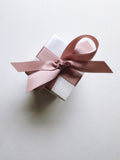 Assorted Sugarfina Wrapped Sugarfina Cube chocolates and candies in colorful packaging, set of 20, on a white background.